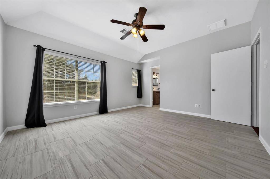 Primary bedroom, enjoy bright lighting from the large picture window.