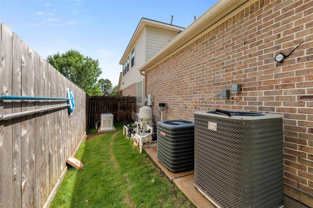 Side yard features full house generator (2023), pool equipment, and two A/C units neatly tucked away and space for convenient utility access