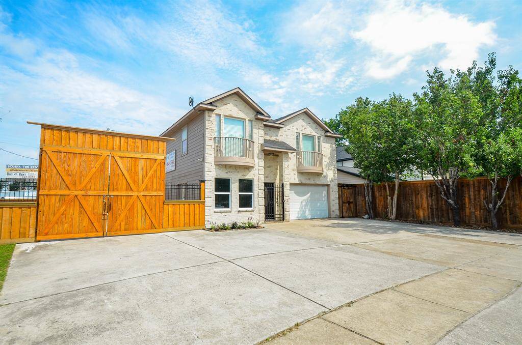 Front of the home with custom wood gate