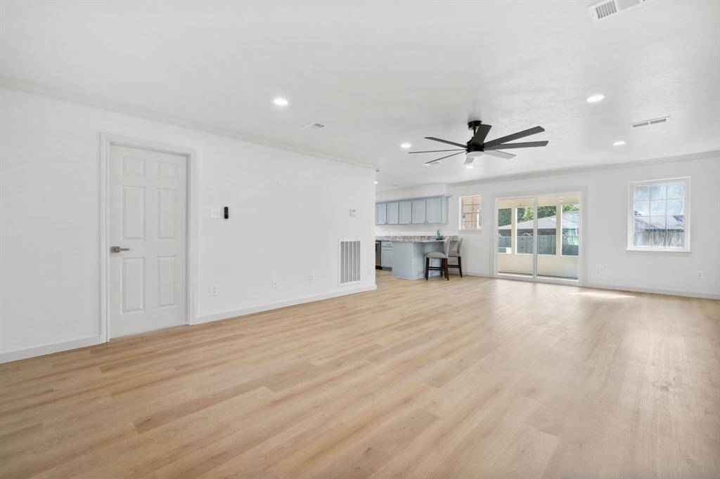 Step inside your light-filled living room, which leads into dining, screened porch, and kitchen