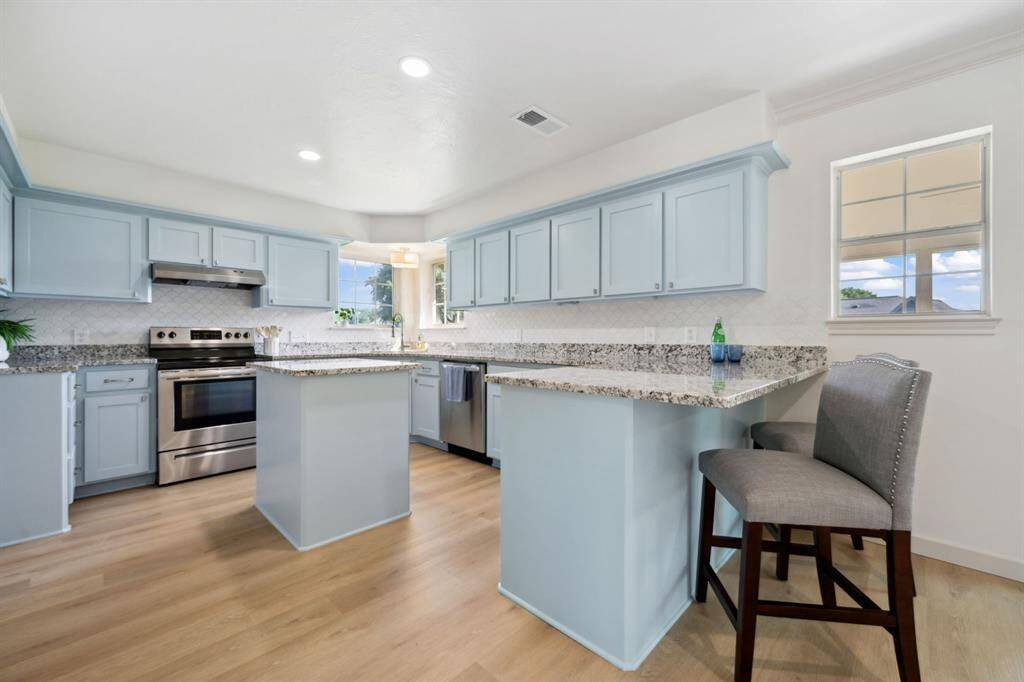 Stainless steel appliances, granite countertops, and under-cabinet lighting complete this chef's kitchen