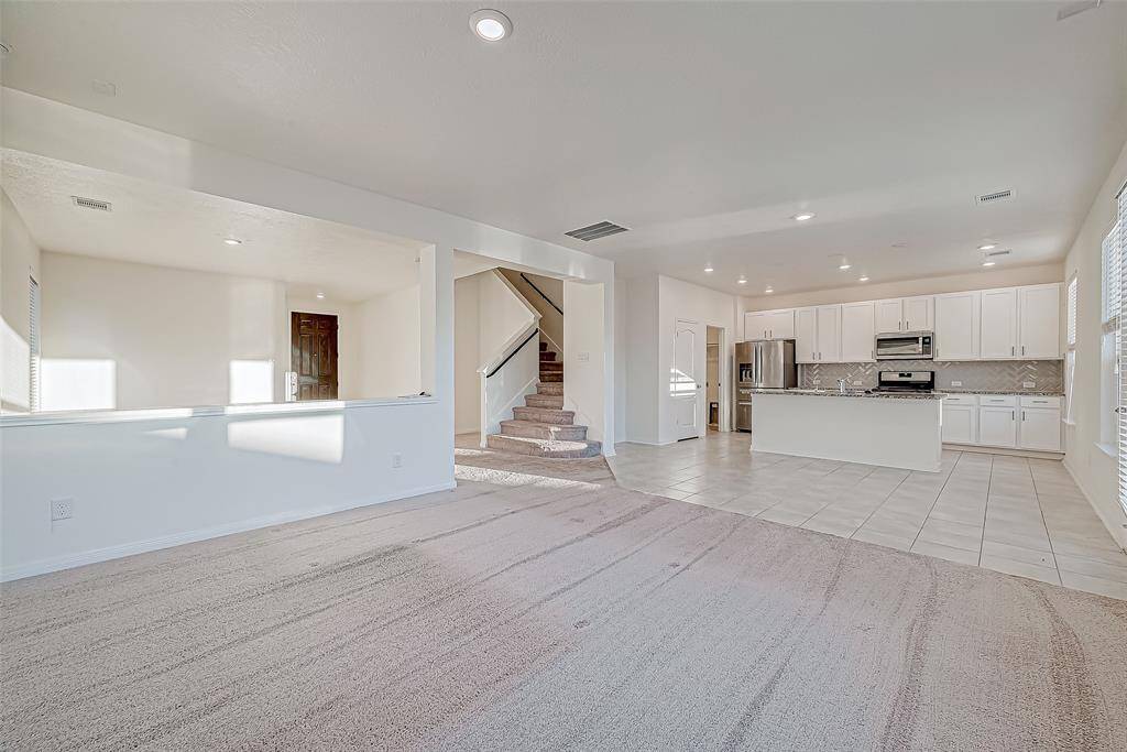 This open-concept layout brings everyone together, with the spacious family room flowing effortlessly into the bright breakfast area, modern island kitchen, and adjoining flex or formal living room. This floor plan offers versatile spaces for both everyday living and entertaining.