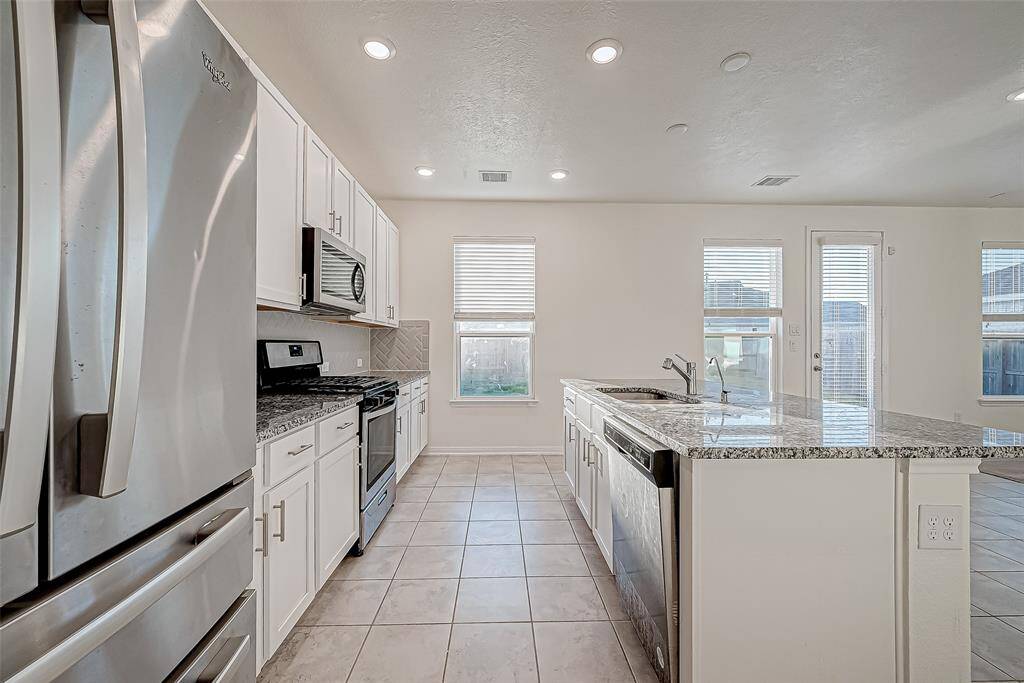 Whip up something tasty in this stylish kitchen, where stainless steel appliances, an oversized island, and loads of elbow room make every meal a little more fun. With plenty of space to prep, cook, and clean up, this bright and functional layout is ready for anything from Saturday morning pancakes to quick weeknight meals.