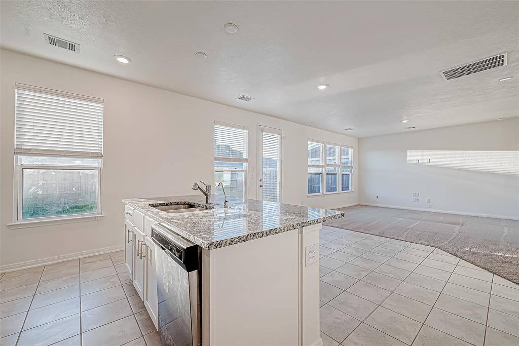 Whether you're prepping dinner or pouring drinks, the kitchen island keeps you at the center of it all. With open views into the living area and plenty of natural light, this bright space makes everyday moments feel a little more special.