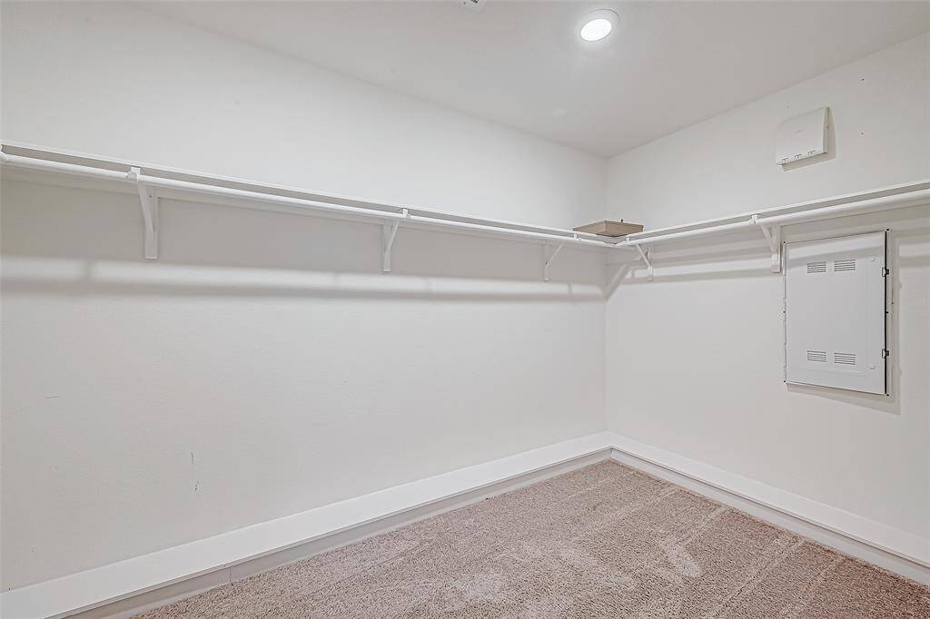 Shop until you drop! This massive walk-in closet has plenty of space for hanging clothes, bags, shoes and more.
