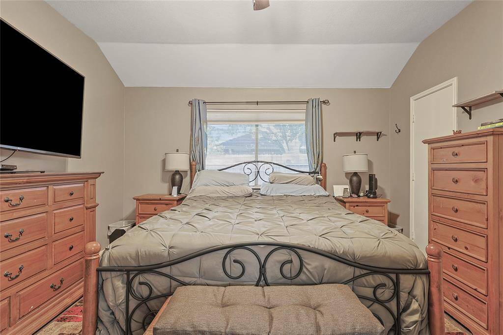 Spacious master bath with modern tile floors and updated shower