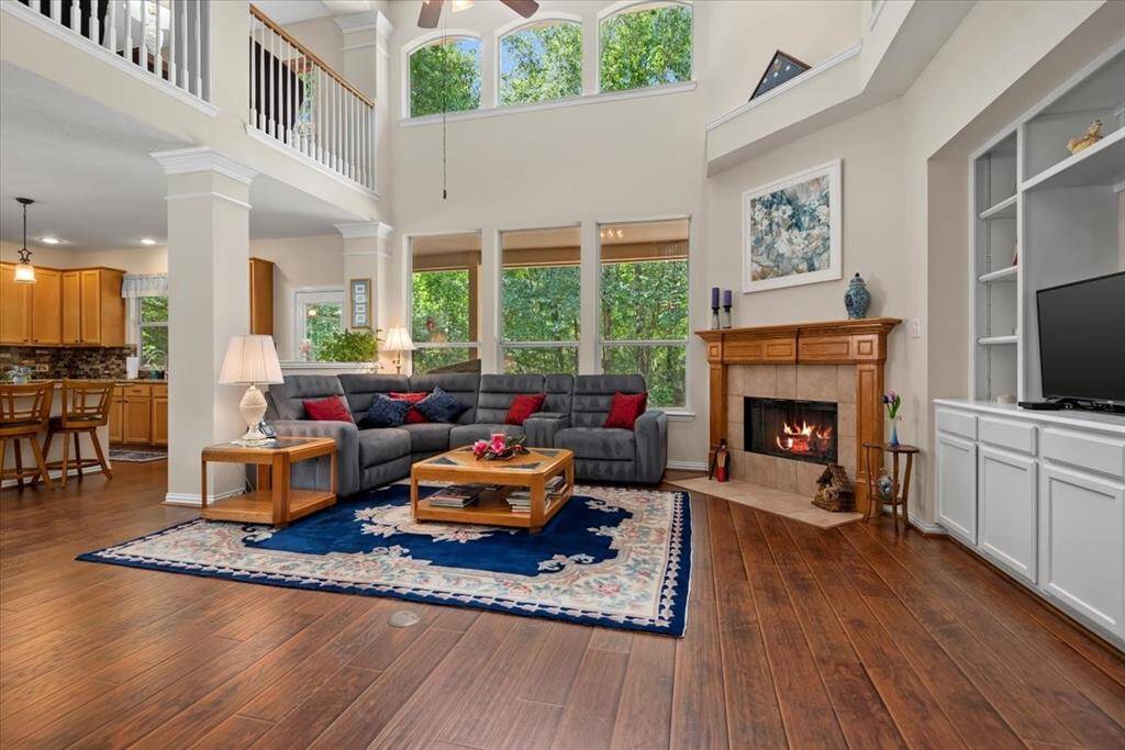 Open living room has space for everyone! Gas log fireplace and built-in storage.