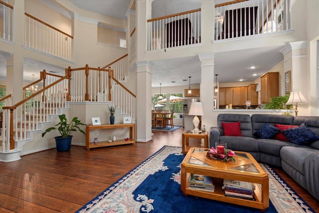 Downstairs living room open to kitchen, entry and dining room.