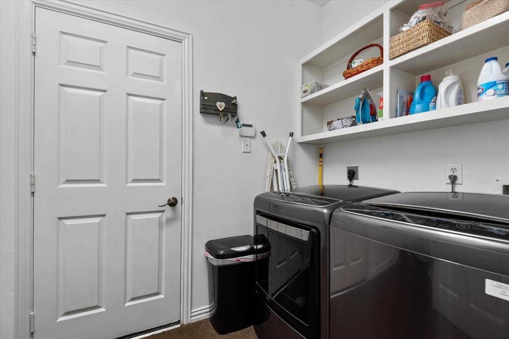 Nice sized utility room with door to oversized garage.