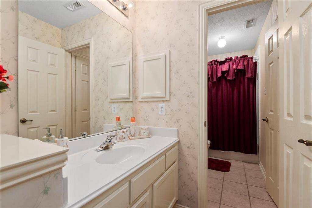 Upstairs bath opens to fourth bedroom and hallway.