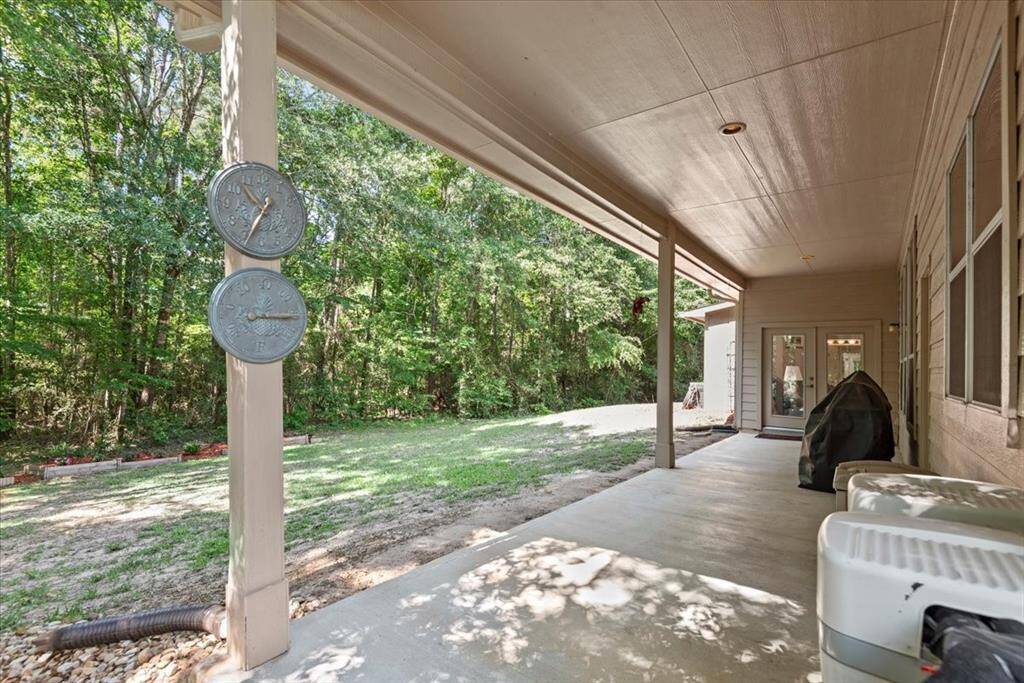 Back porch overlooks the back of the property connects to primary suite. Home also has a whole home water softener.