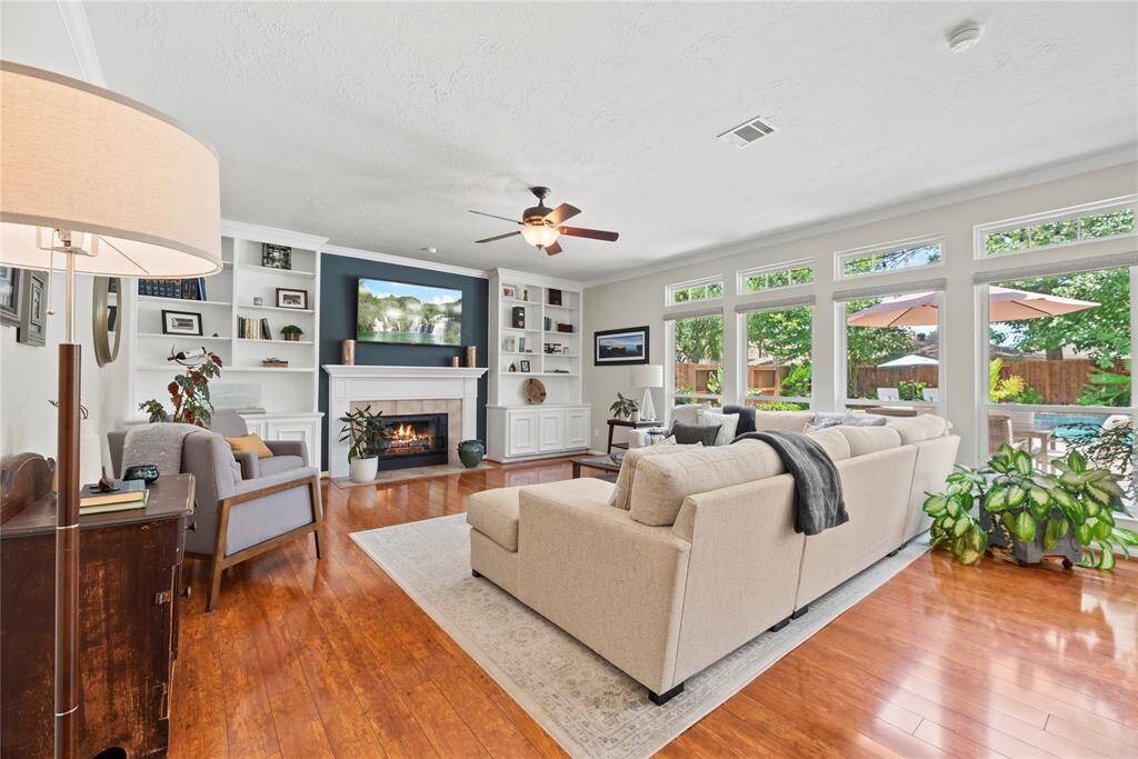This chic living room space has a great feel with tons of natural light coming from the wall of windows. Detail is everywhere.