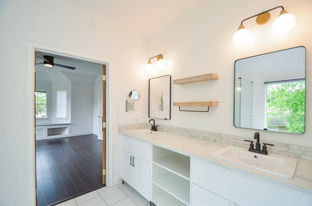 In the primary bathroom, double sinks and updated vanity, lights, mirrors.