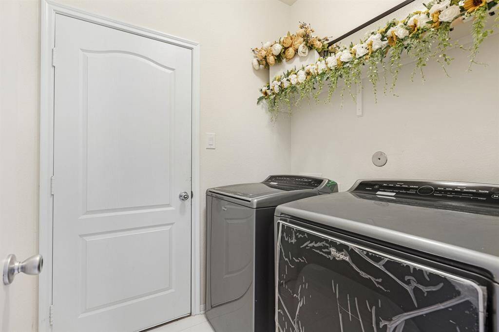 The laundry room features tile floors,washer and dryer connections, andplenty of storage space.