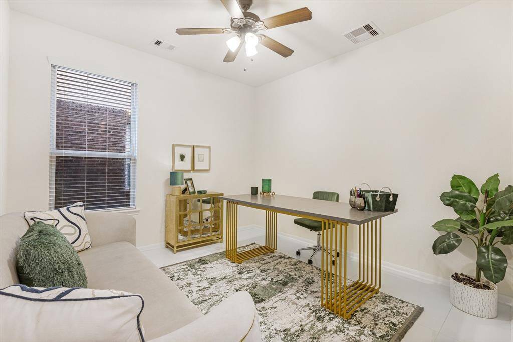 Transform your work routine into ahaven of productivity and comfort inthis thoughtfully designed homeoffice featuring tile floors, ceiling fan, and large window.