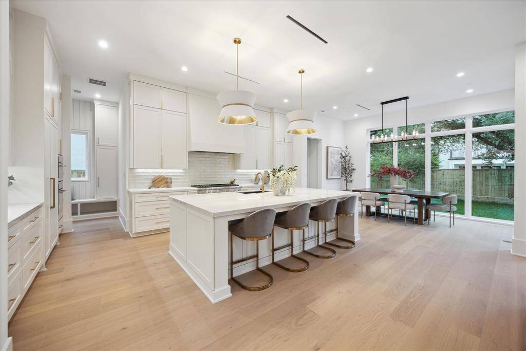 Bathed in natural light, thanks to windows that gracefully wrap around the walls, flooding the space with brightness.