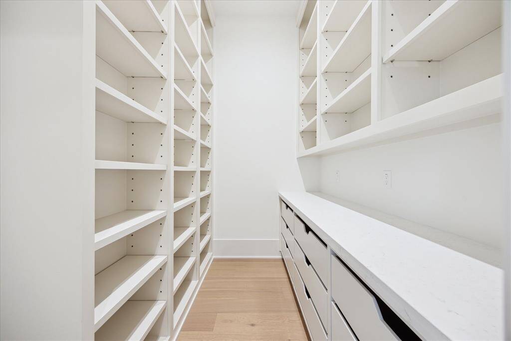 [PANTRY] The spacious walk-in pantry is thoughtfully designed with custom cabinetry, ample shelving, and convenient countertops—offering abundant storage and workspace