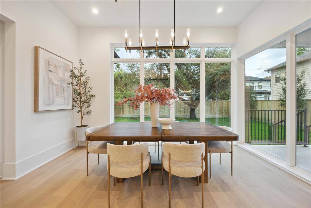 [BREAKFAST/MORNING ROOM] The bright morning room is beautifully wrapped with walls of windows, offering stunning views of the lush yard and outdoor living spaces. This serene spot is perfect for enjoying your morning coffee while soaking in the natural beauty and tranquility of the surroundings