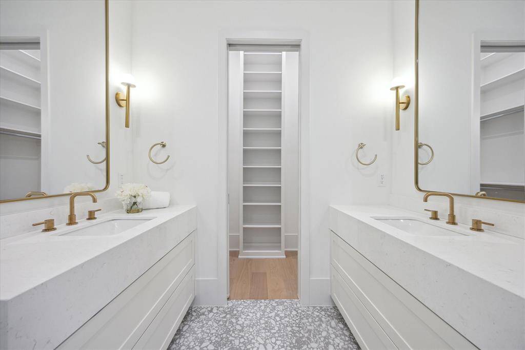 The guest en suite bathroom offers both comfort and sophistication, featuring two separate vanities for added convenience and privacy.