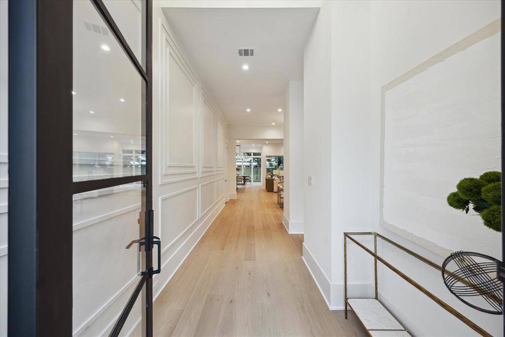 [ENTRANCE] Welcome Home! Step through the elegant glass front door into a grand foyer that sets the tone for the home’s exceptional craftsmanship. From custom millwork to thoughtfully curated finishes, every detail in this welcoming entryway speaks to timeless design and quality artistry.