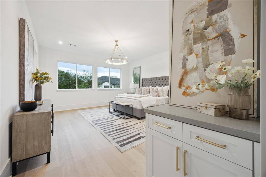[PRIMARY SUITE] The gracious primary bedroom is a serene retreat, featuring soaring expansive windows that fill the room with natural light. A built-in coffee station adds a touch of everyday luxury, making this French contemporary haven the perfect place to begin and end your day in comfort and style.
