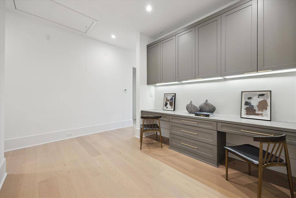 [HOMEWORK STATION] The second-floor homework and activity station offers a versatile space designed for productivity and creativity. With built-in work surfaces and sleek cabinetry, this thoughtfully placed nook reflects the home’s contemporary elegance while providing a functional area for study, projects, or quiet focus.