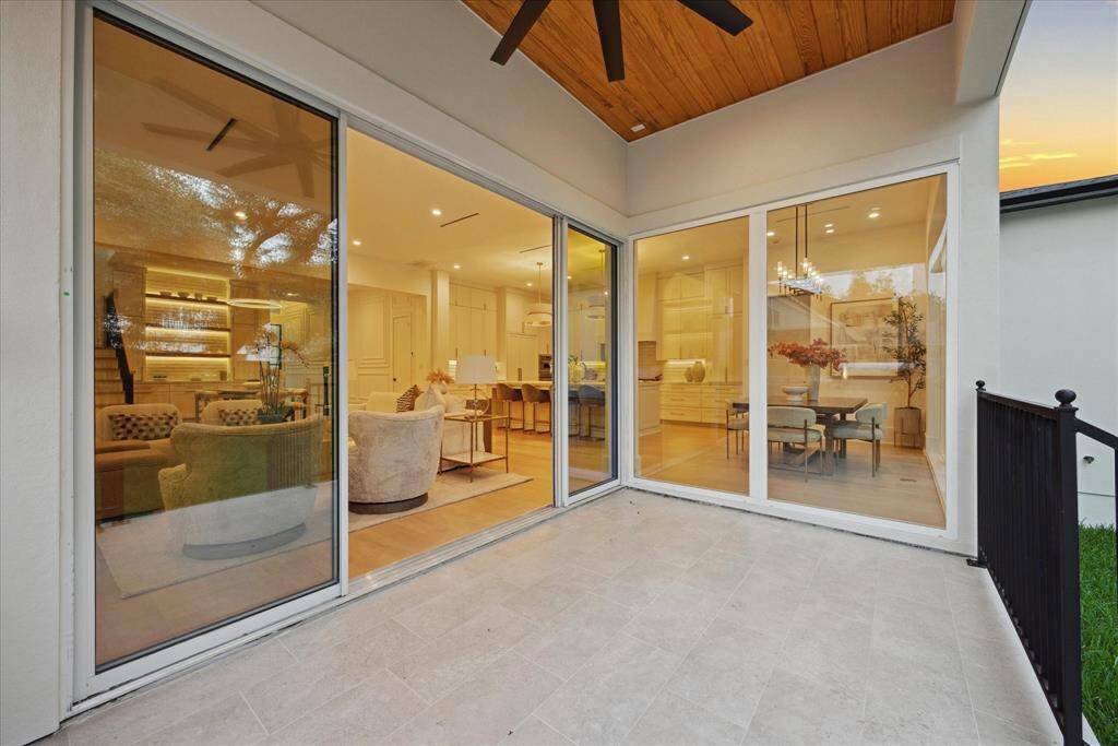 This outdoor space seamlessly blends with the indoors through expansive glass sliding doors, creating a fluid transition between interior comfort and open-air living. Designed for effortless entertaining and relaxation!
