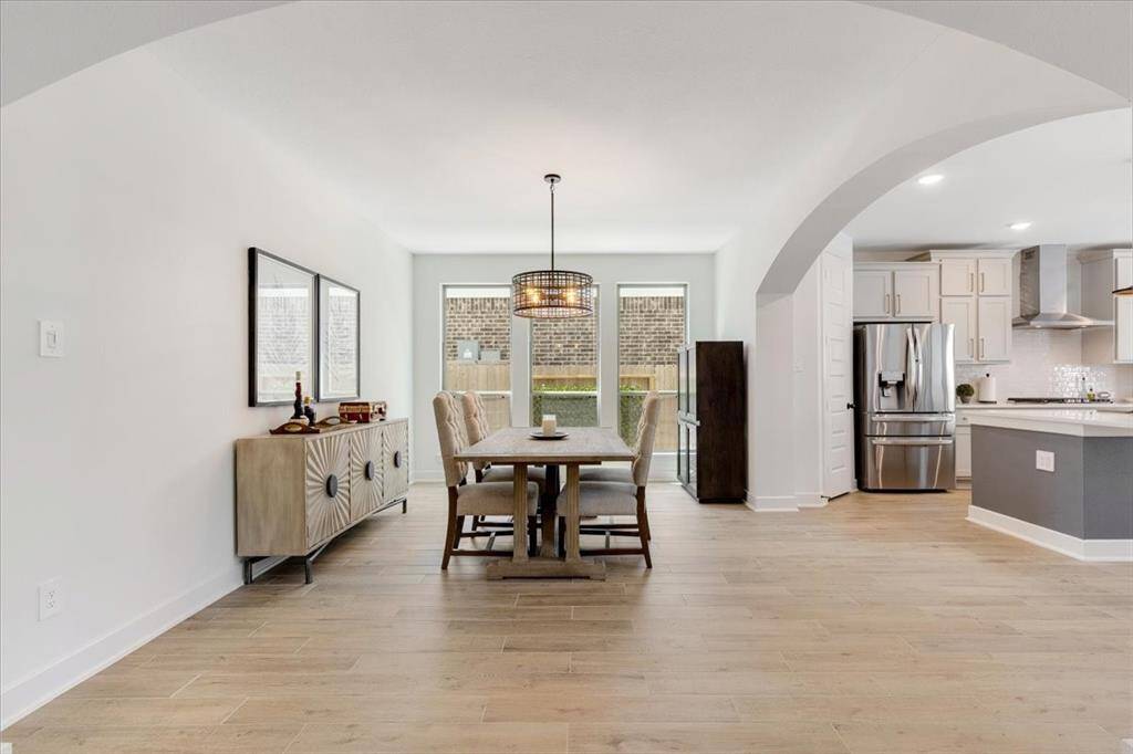 The dining room is light-filled and airy, creating a warm and inviting atmosphere.