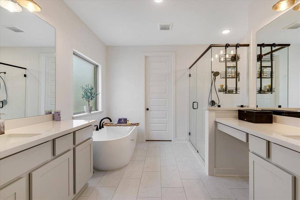 Another perspective from the primary retreat reveals the entrance to the primary bath, with a spacious walk-in closet just beyond the door that connects conveniently to the laundry room.