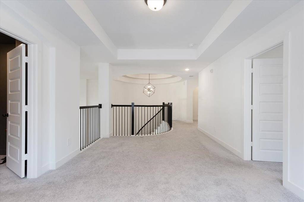 At the top of the stairs, you'll discover a generously sized game room, a media room to the left, and a guest bedroom to the right.