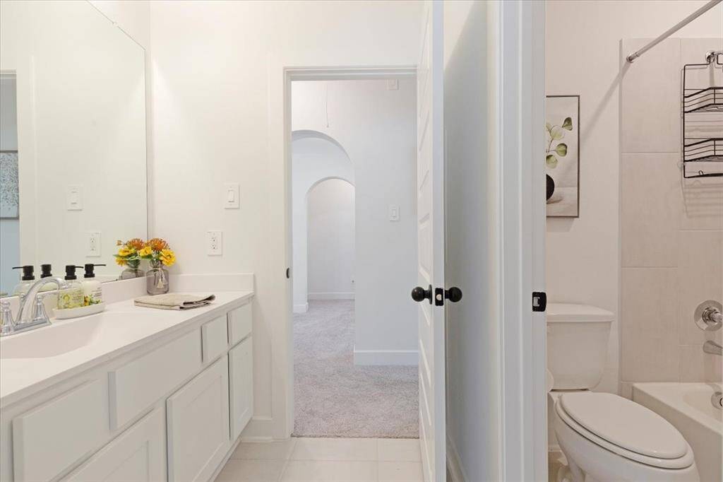 This upstairs full bathroom conveniently serves two guest bedrooms.