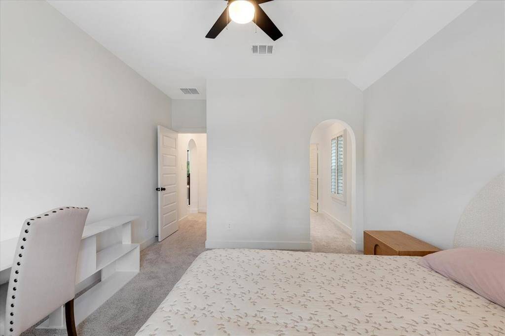 Another view of the guest bedroom, which includes a private hallway leading to a full bathroom.
