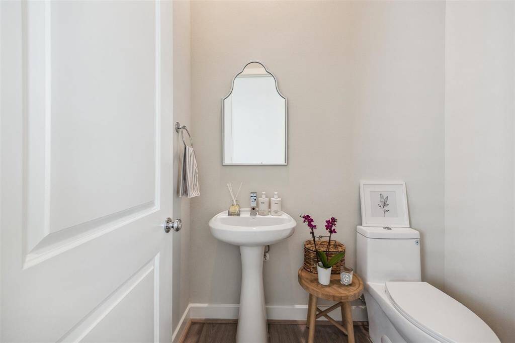 Powder bathroom located at split level between first and second floors