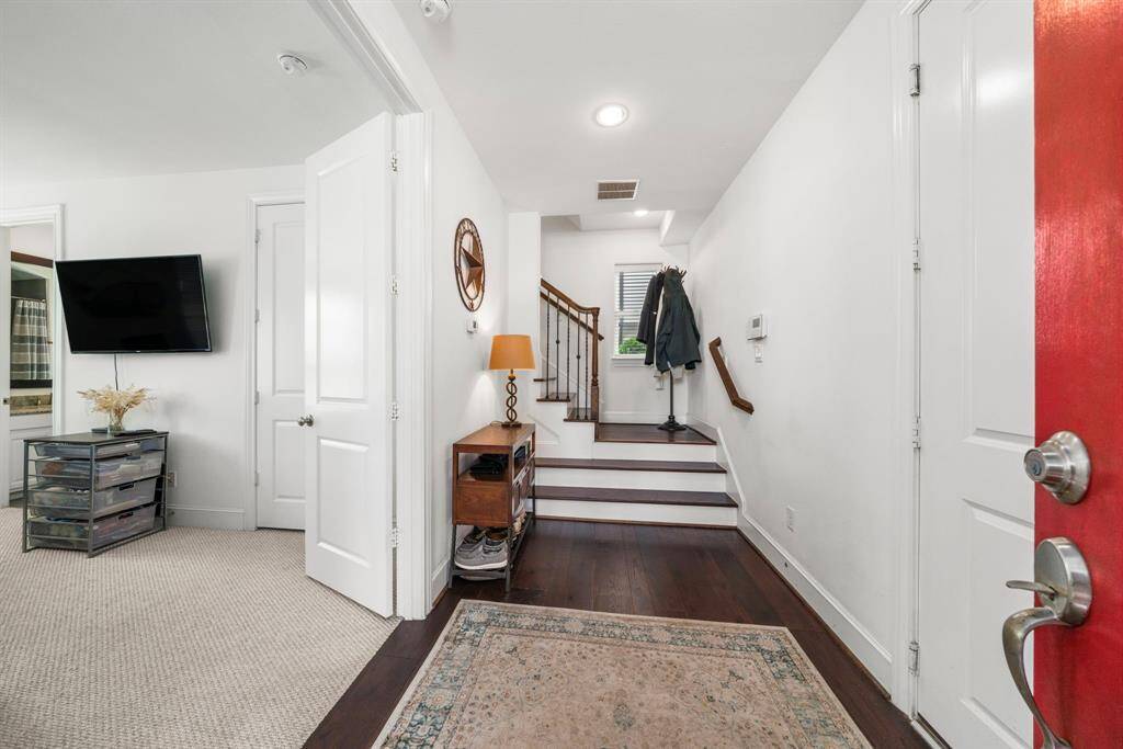 As you enter, you'll notice the 1st floor secondary bedroom suite, which could also be a home office.