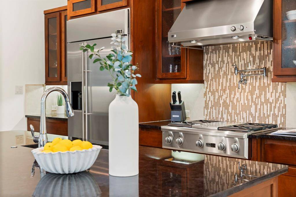 Kitchen Features Stainless Steel Appliances and a Built In Refrigerator
