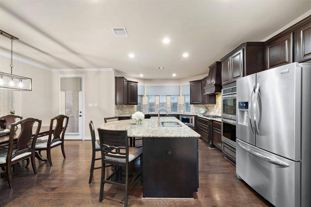 With generous counter space and direct access to the dining area, this kitchen balances form and function with timeless finishes and practical flow.