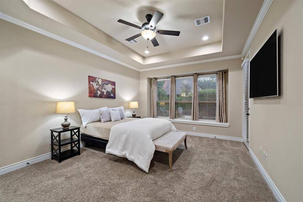 Oversized windows draw in natural light while offering views of the backyard, adding brightness and privacy to the spacious layout.