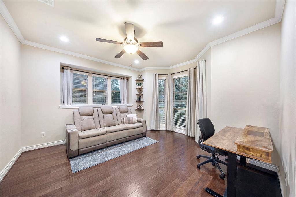 The study offers a finished interior room with wood flooring and two tall windows, designed with the same attention to detail found throughout the home.