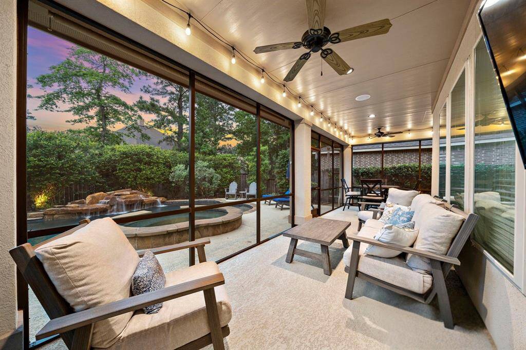 The extended patio enclosure enhances the home’s entertaining flow, offering a protected environment for gatherings alongside clear views of the backyard.