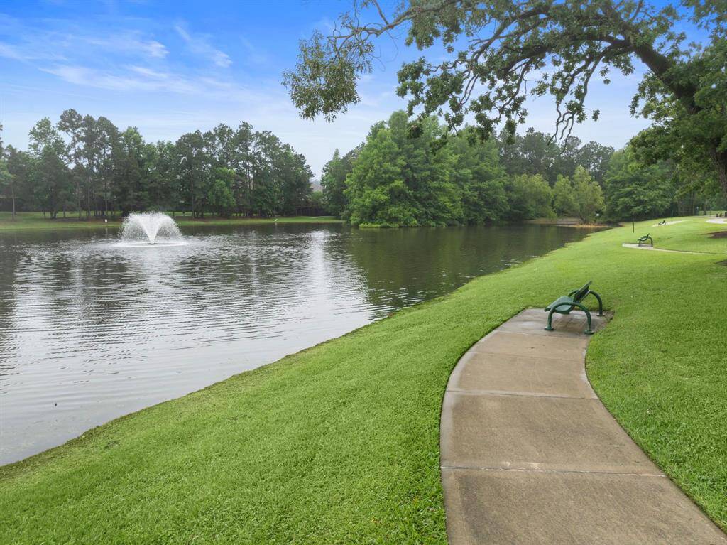 Enjoy peaceful views of the scenic community lake, complete with a central fountain and shaded walking path. Benches along the path offer a relaxing spot to unwind or take in the surrounding greenery—perfect for daily strolls or quiet moments outdoors.