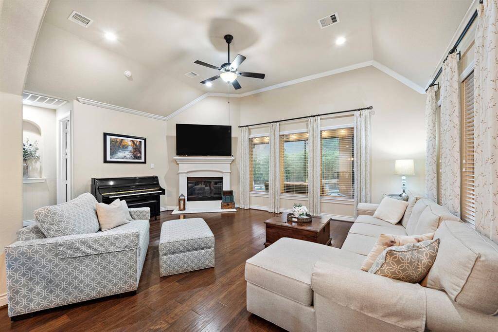 Defined by high ceilings and crown molding, this spacious living room centers around a gas log fireplace and offers flexible layout options for gatherings or quiet evenings in.