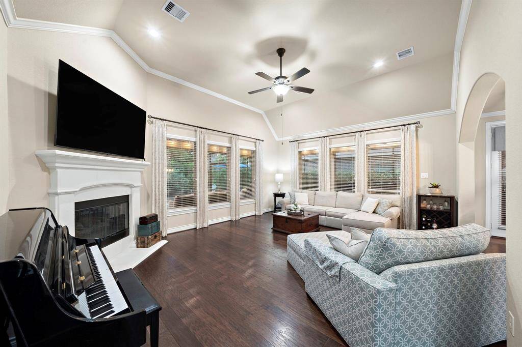 Abundant natural light filters through a wall of windows, enhancing the open feel and highlighting the home’s seamless connection to the outdoor entertaining spaces.