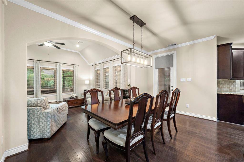 This dining area benefits from its close placement to the living room, making it easy to serve guests or transition between everyday activities.