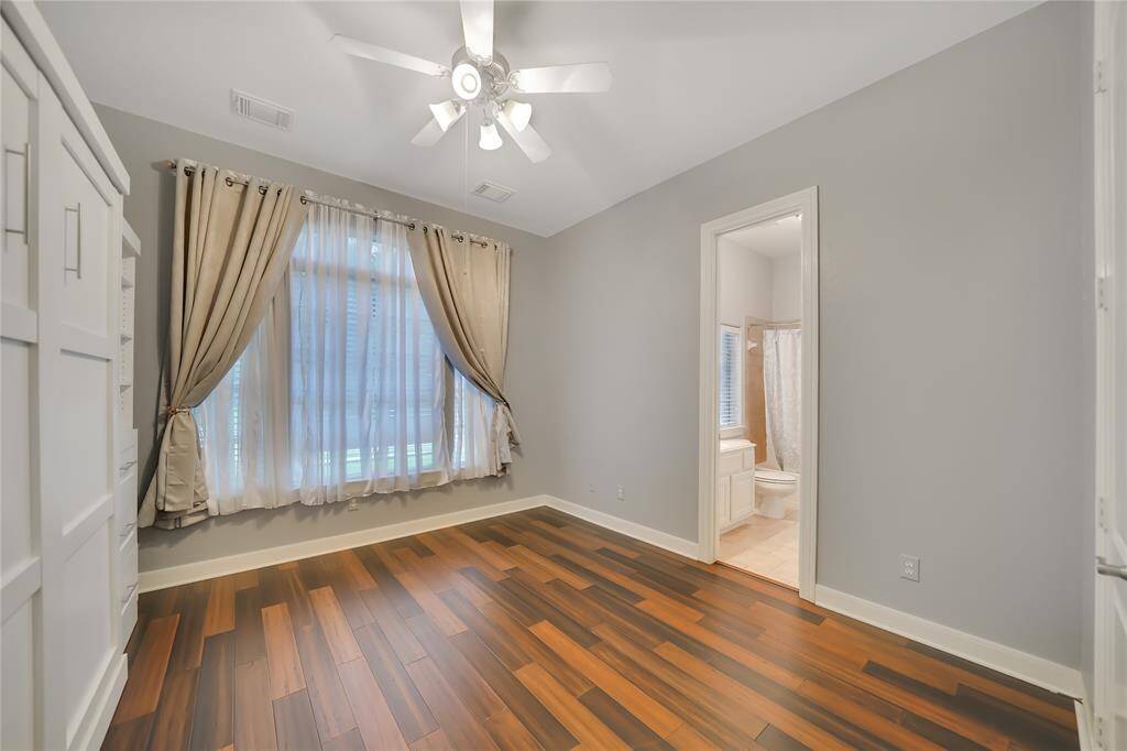 Second bedroom downstairs with wood flooring, en suite & murphy bed - could also make a great second study,