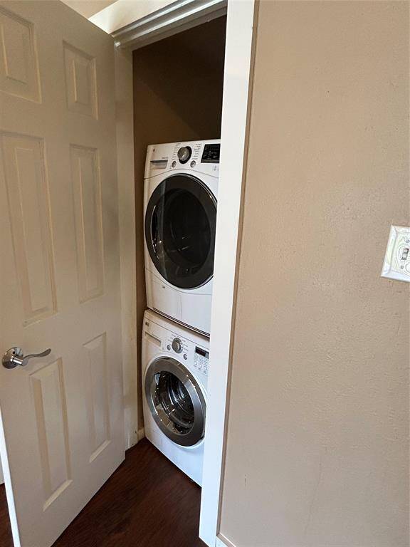 Laundry room showing stacked washer/dryher