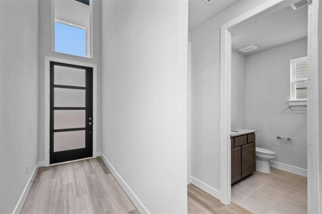 Step into an inviting, sunlit foyer that sets a welcoming tone for your home.