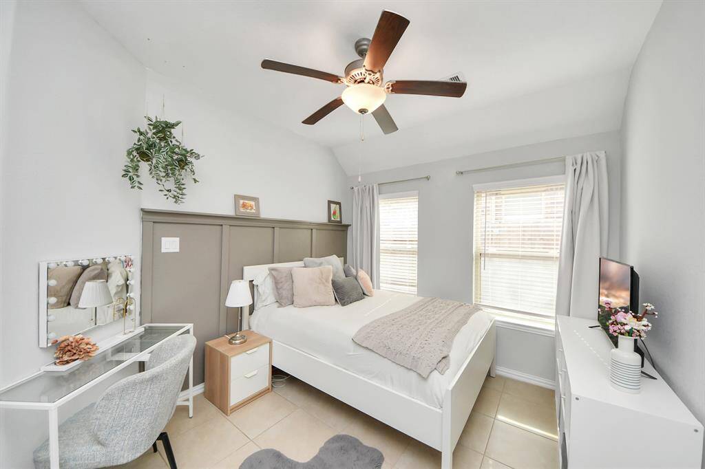 2nd of 4 total bedrooms with high ceilings and filled with natural light.