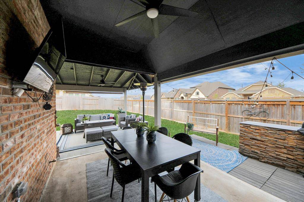 A massive covered patio with custom extensions & outdoor kitchen area!