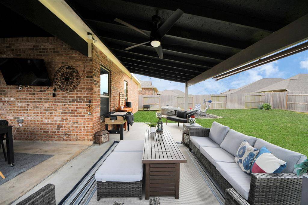 Covered patio wraps around the back of the house, too!