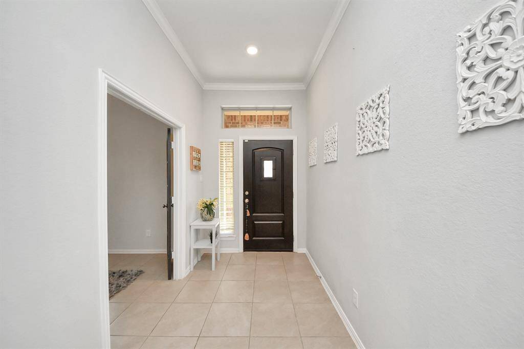 Another view of the tiled foyer with high ceilings!